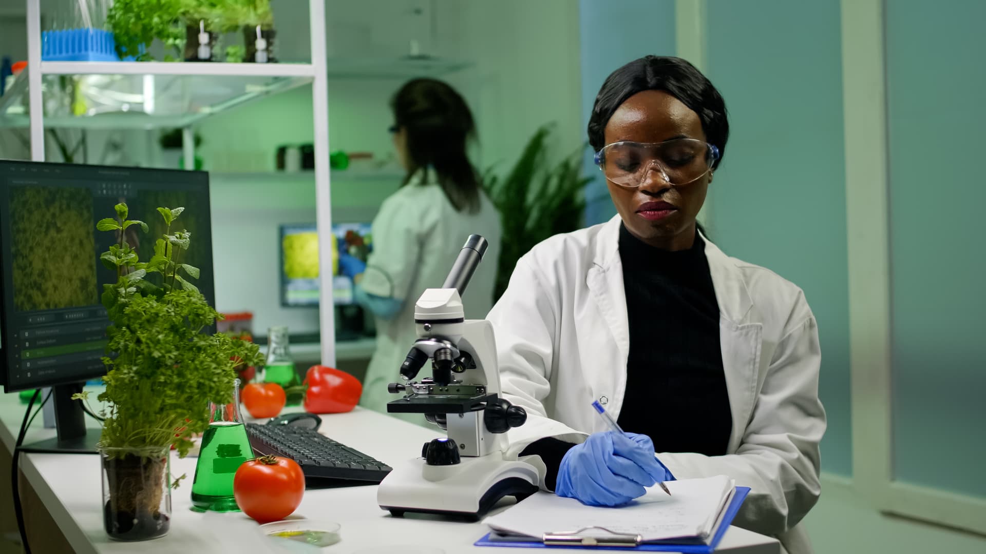 Scientist reviewing plant tissue samples in a research laboratory
